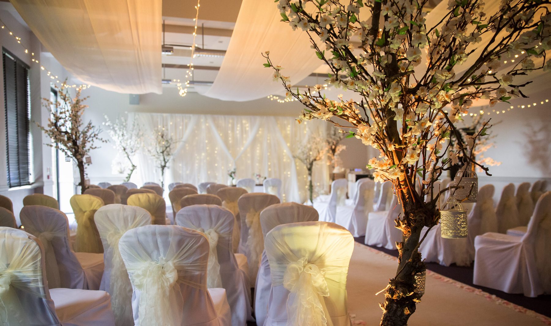 Softly dressed indoor ceremony room at Denham Grove