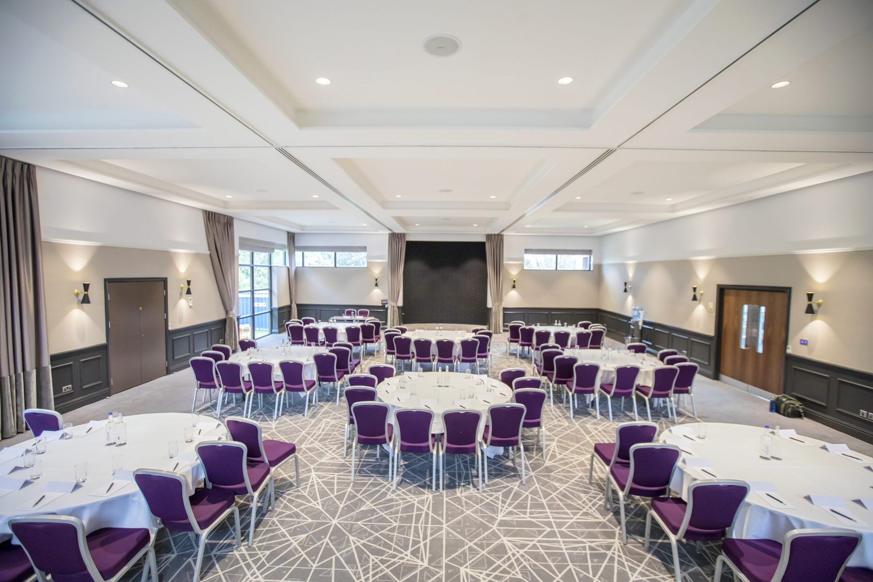 Event suite set with round tables at Denham Grove